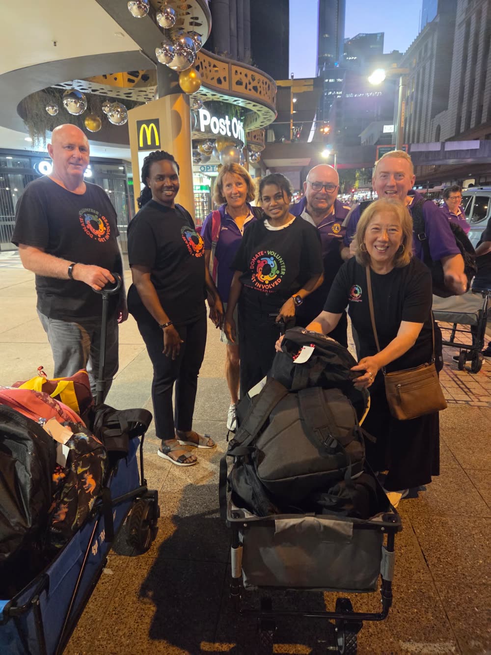 Daily Bread House volunteers preparing backpacks and supplies to hand out.